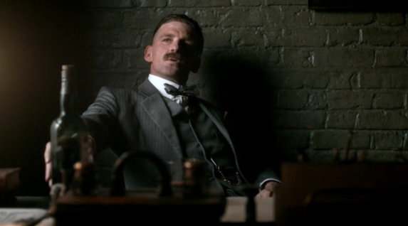 Arthur kingly holds bottle